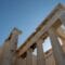 Ancient temple ruins with tall marble columns against a clear blue sky