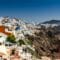 White-washed houses and blue-domed churches cling to a cliff above the deep blue Aegean Sea in Santorini.](https://)